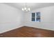 Formal dining room with hardwood floors, white walls, and an elegant chandelier at 1210 Huntsman Dr, Durham, NC 27713