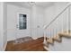 Inviting entryway featuring hardwood floors, white trim, and a staircase to the upper level at 1210 Huntsman Dr, Durham, NC 27713