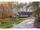 Charming brick home with mature trees and a well-manicured lawn at 1210 Huntsman Dr, Durham, NC 27713