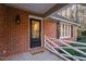 Inviting front door with classic brick facade and welcoming mat enhance the home's curb appeal at 1210 Huntsman Dr, Durham, NC 27713