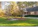 Charming red brick home with a well-manicured front yard and inviting entryway, surrounded by mature trees at 1210 Huntsman Dr, Durham, NC 27713