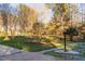 A nicely manicured front yard with mature trees and green grass creates charming curb appeal at 1210 Huntsman Dr, Durham, NC 27713