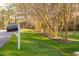 Well-manicured front yard with a mailbox showing the address at 1210 Huntsman Dr, Durham, NC 27713