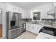 Charming kitchen features stainless steel appliances, granite countertops, and white cabinets at 1210 Huntsman Dr, Durham, NC 27713