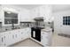 The lovely kitchen features a modern cooktop, ample counter space, and white cabinetry at 1210 Huntsman Dr, Durham, NC 27713