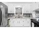 This well-lit kitchen includes a stainless steel refrigerator, sleek countertops, and updated fixtures at 1210 Huntsman Dr, Durham, NC 27713