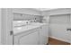 Laundry area with a white washer and dryer set, with built-in shelves above for storage at 1210 Huntsman Dr, Durham, NC 27713