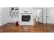 Sunlit living room featuring a fireplace and built-in shelving and cabinets at 1210 Huntsman Dr, Durham, NC 27713
