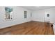 Spacious room with hardwood floors, white walls, large windows and a ceiling fan at 1210 Huntsman Dr, Durham, NC 27713