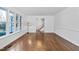 Bright living room features hardwood floors, large windows, and staircase access at 1210 Huntsman Dr, Durham, NC 27713