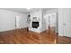 Bright living room featuring wood floors, a brick fireplace, and built-in shelves at 1210 Huntsman Dr, Durham, NC 27713