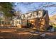A multi-level home with brick and wood shingle exterior, stone pathway, and screened in porch at 1210 Huntsman Dr, Durham, NC 27713