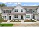 Three-unit townhome building with white and gray siding, landscaping, and parking at 124 Camel Crazies Pl # 43, Lillington, NC 27546