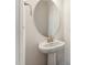 Small powder room with pedestal sink and round mirror at 124 Camel Crazies Pl # 43, Lillington, NC 27546