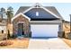 Charming home with stone accents, a two-car garage, and well-maintained landscaping at 213 Little Crk Dr, Lillington, NC 27546