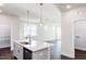 Kitchen with a large island, stainless steel sink, and lots of natural light at 213 Little Crk Dr, Lillington, NC 27546