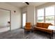 Spacious living room with hardwood floors, large windows, and access to a patio at 2206 Gathering Sq Ct # 2206, Fuquay Varina, NC 27526