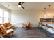 Living room with hardwood floors, ceiling fan, and a view of the kitchen at 2206 Gathering Sq Ct # 2206, Fuquay Varina, NC 27526