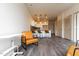 Open living room with hardwood floors and tan leather armchairs at 2206 Gathering Sq Ct # 2206, Fuquay Varina, NC 27526