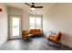 Spacious living area with two comfy leather chairs and large windows at 2206 Gathering Sq Ct # 2206, Fuquay Varina, NC 27526