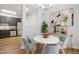 Virtually staged dining area with a round table and four chairs at 2225 Raven Rd # 107, Raleigh, NC 27614