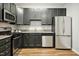 Modern kitchen with dark cabinets and stainless steel appliances at 2225 Raven Rd # 107, Raleigh, NC 27614