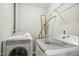 Laundry room with washer, dryer, and shelving at 2225 Raven Rd # 107, Raleigh, NC 27614