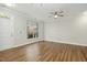 Living room with hardwood floors and a large window, showcasing natural light at 2225 Raven Rd # 107, Raleigh, NC 27614