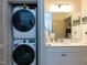 Bathroom and laundry area features a stackable washer/dryer and modern vanity at 2313 Gathering Square Ct # 2313, Fuquay Varina, NC 27526