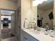 Bright bathroom features white vanity, modern fixtures, and a view of the kitchen at 2313 Gathering Square Ct # 2313, Fuquay Varina, NC 27526