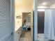 Bathroom includes double doors with white vanity, modern fixtures, and shower with grey backsplash at 2313 Gathering Square Ct # 2313, Fuquay Varina, NC 27526