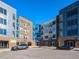 View of modern apartment buildings showcasing a mix of brick and metal facades, balconies, and street parking at 2313 Gathering Square Ct # 2313, Fuquay Varina, NC 27526