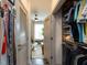 Hallway with organized closet space and a glimpse into the living room at 2313 Gathering Square Ct # 2313, Fuquay Varina, NC 27526