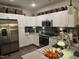 Modern kitchen with white cabinets, granite countertops and stainless steel appliances at 2313 Gathering Square Ct # 2313, Fuquay Varina, NC 27526