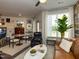 Cozy living room featuring comfortable seating, a large window, and a unique bookcase at 2313 Gathering Square Ct # 2313, Fuquay Varina, NC 27526