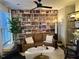 Inviting living room featuring a ceiling fan, wallpapered bookshelf, and comfortable seating at 2313 Gathering Square Ct # 2313, Fuquay Varina, NC 27526