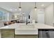 Kitchen island with farmhouse sink, overlooks living room at 244 Wood Orchid Ln, Garner, NC 27529