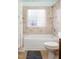 Bathroom with tub, shower, and block window at 3 Moss Spring Ct, Durham, NC 27712