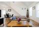 Living room with hardwood floors, a sofa, and access to the dining area at 3 Moss Spring Ct, Durham, NC 27712