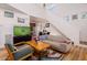 Bright living room with hardwood floors, comfy seating and a large TV at 3 Moss Spring Ct, Durham, NC 27712