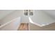 Upstairs hallway with hardwood floors and white railings at 3 Moss Spring Ct, Durham, NC 27712