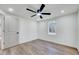 Spacious bedroom featuring hardwood floors, a ceiling fan, and a window with natural light at 406 Everette Ave, Clayton, NC 27520