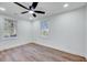 Well-lit bedroom with two windows, ceiling fan and hardwood floors at 406 Everette Ave, Clayton, NC 27520