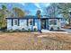 Newly renovated home with gray siding, stone accents, and landscaping at 406 Everette Ave, Clayton, NC 27520