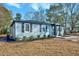 Newly renovated home with gray siding, stone accents, and landscaping at 406 Everette Ave, Clayton, NC 27520
