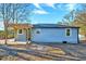 Rear view of charming house with gray siding and pergola-covered patio at 406 Everette Ave, Clayton, NC 27520