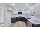 Modern kitchen with white and dark cabinets, marble countertops, and stainless steel appliances at 406 Everette Ave, Clayton, NC 27520