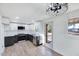 Modern kitchen features white and dark cabinets, marble countertops, and stainless steel appliances at 406 Everette Ave, Clayton, NC 27520