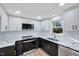 Modern kitchen with white and black cabinets, marble countertops and stainless steel appliances at 406 Everette Ave, Clayton, NC 27520