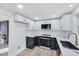 Modern kitchen with white and black cabinets, marble countertops, and stainless steel appliances at 406 Everette Ave, Clayton, NC 27520